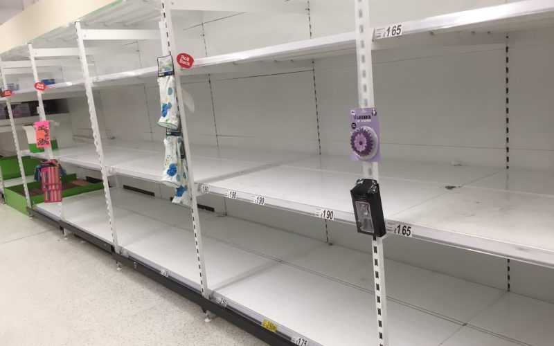 Empty shelves in a supermarket repurposed for storytelling
